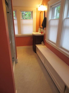 turning that corner to the left, the shower's ahead and left, the window seat opens in front for storage